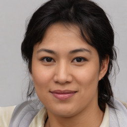 Joyful asian young-adult female with medium  brown hair and brown eyes