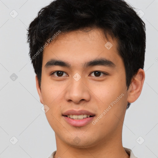 Joyful asian young-adult male with short  brown hair and brown eyes