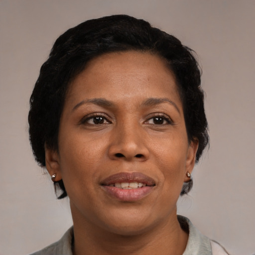 Joyful black adult female with short  black hair and brown eyes