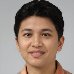 Joyful asian young-adult male with short  black hair and brown eyes