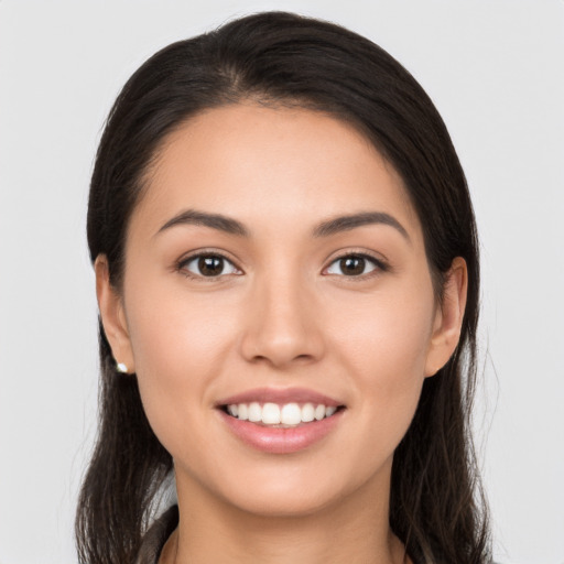 Joyful white young-adult female with long  brown hair and brown eyes