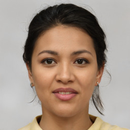 Joyful latino young-adult female with medium  brown hair and brown eyes