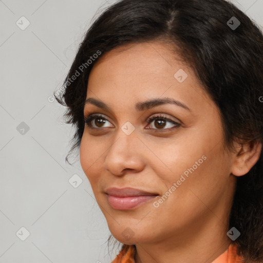 Joyful latino young-adult female with medium  brown hair and brown eyes