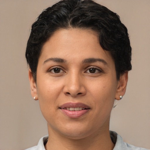 Joyful latino young-adult female with short  brown hair and brown eyes