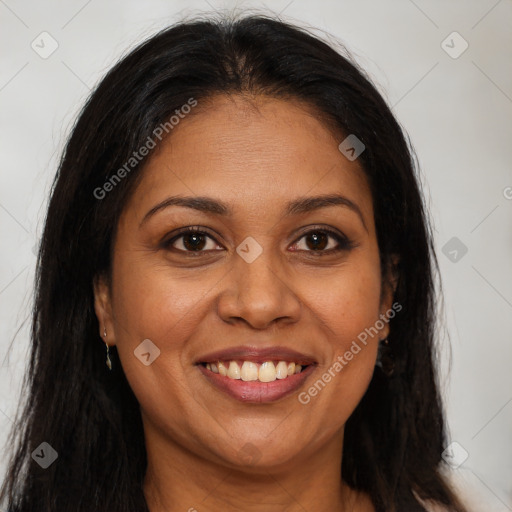 Joyful black young-adult female with long  brown hair and brown eyes