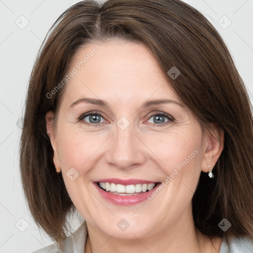 Joyful white adult female with medium  brown hair and grey eyes