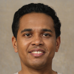 Joyful black young-adult male with short  brown hair and brown eyes