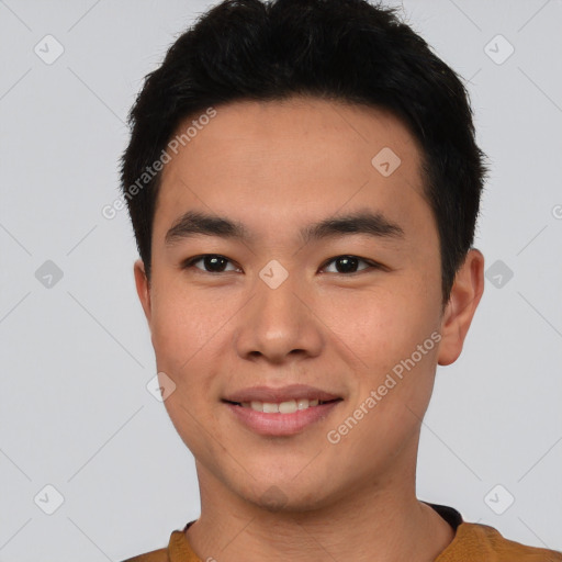 Joyful asian young-adult male with short  black hair and brown eyes