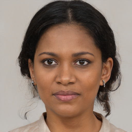 Joyful black young-adult female with medium  brown hair and brown eyes