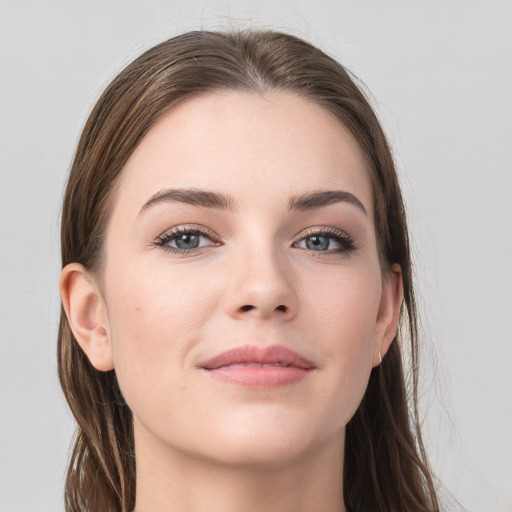 Joyful white young-adult female with long  brown hair and grey eyes