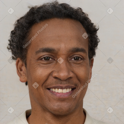 Joyful black adult male with short  brown hair and brown eyes
