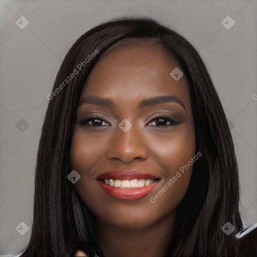 Joyful black young-adult female with long  black hair and brown eyes