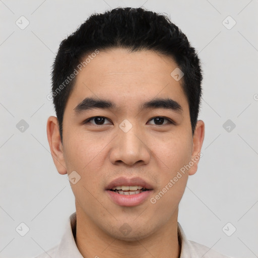 Joyful asian young-adult male with short  black hair and brown eyes