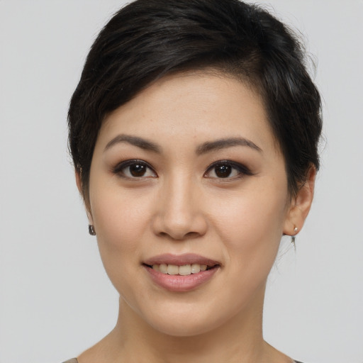 Joyful asian young-adult female with short  brown hair and brown eyes