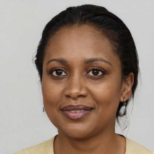 Joyful black adult female with medium  black hair and brown eyes