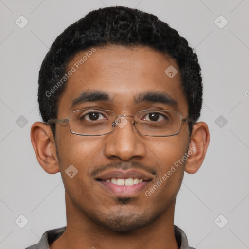 Joyful black young-adult male with short  black hair and brown eyes