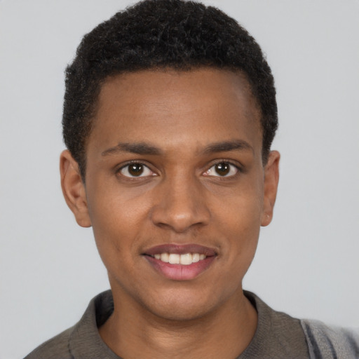 Joyful black young-adult male with short  black hair and brown eyes