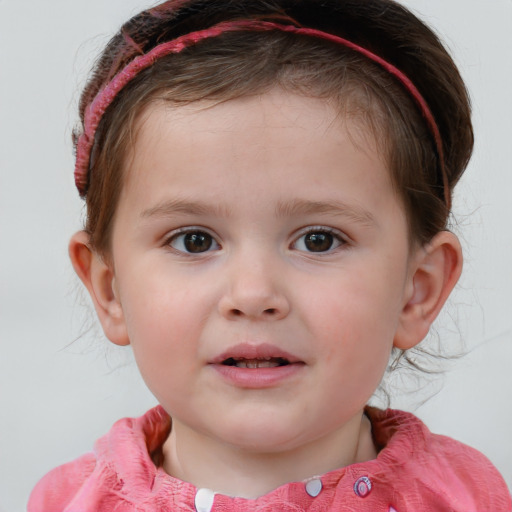 Joyful white child female with short  brown hair and blue eyes