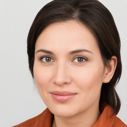 Joyful white young-adult female with medium  brown hair and brown eyes