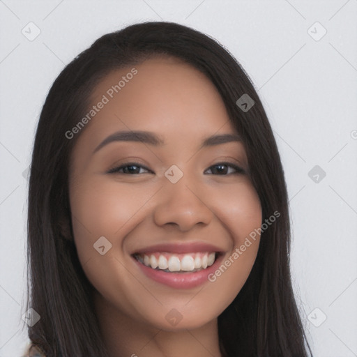 Joyful latino young-adult female with long  brown hair and brown eyes