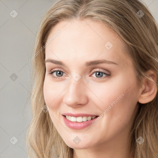 Joyful white young-adult female with long  brown hair and blue eyes