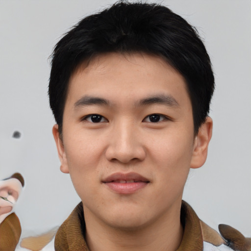 Joyful asian young-adult male with short  black hair and brown eyes