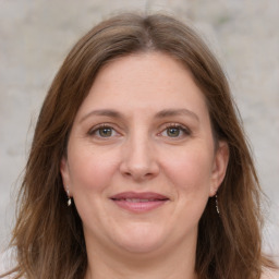 Joyful white adult female with medium  brown hair and grey eyes