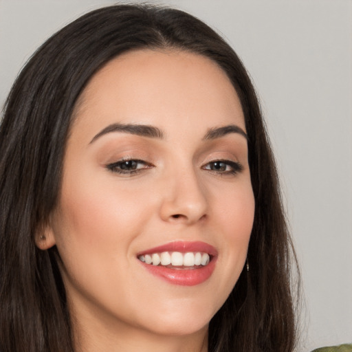 Joyful white young-adult female with long  brown hair and brown eyes