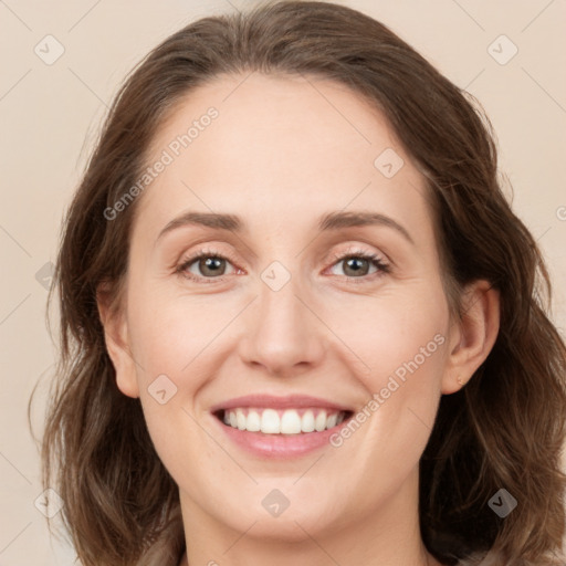 Joyful white young-adult female with medium  brown hair and green eyes