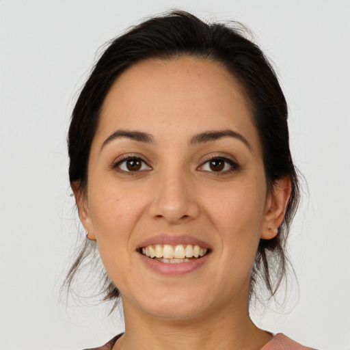 Joyful latino young-adult female with medium  brown hair and brown eyes