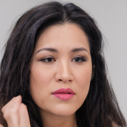 Joyful asian young-adult female with long  brown hair and brown eyes