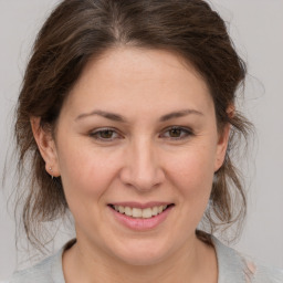 Joyful white adult female with medium  brown hair and brown eyes