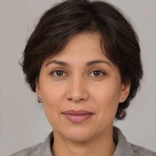 Joyful white adult female with medium  brown hair and brown eyes