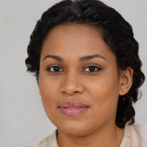 Joyful black young-adult female with long  brown hair and brown eyes