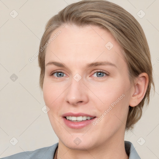 Joyful white young-adult female with medium  brown hair and blue eyes