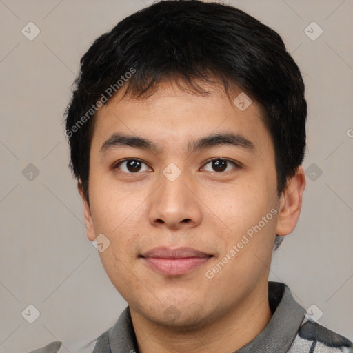 Joyful asian young-adult male with short  black hair and brown eyes