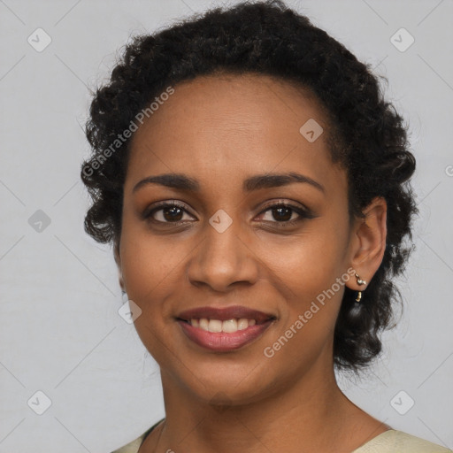 Joyful black young-adult female with long  black hair and brown eyes