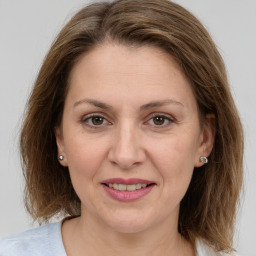 Joyful white adult female with medium  brown hair and grey eyes