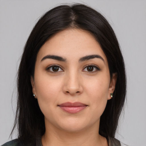 Joyful latino young-adult female with long  brown hair and brown eyes