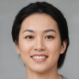 Joyful asian young-adult female with medium  black hair and brown eyes