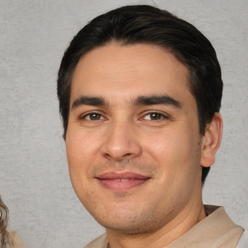 Joyful white young-adult male with short  black hair and brown eyes