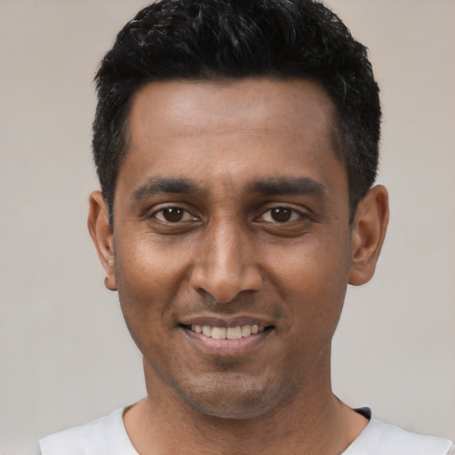 Joyful latino young-adult male with short  black hair and brown eyes
