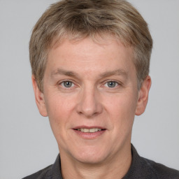 Joyful white adult male with short  brown hair and grey eyes