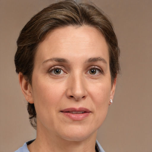 Joyful white adult female with medium  brown hair and grey eyes