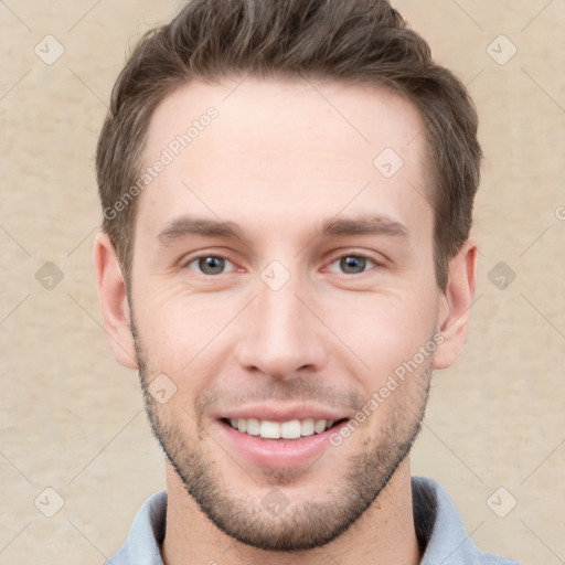 Joyful white young-adult male with short  brown hair and grey eyes