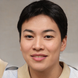 Joyful asian young-adult female with short  black hair and brown eyes