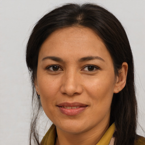 Joyful asian adult female with long  brown hair and brown eyes