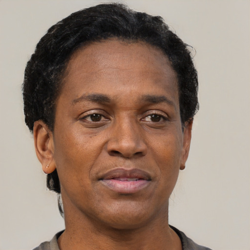 Joyful black adult female with short  black hair and brown eyes