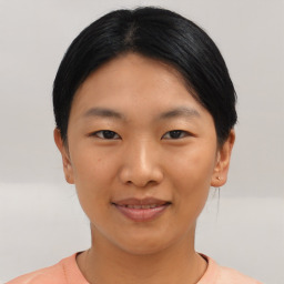 Joyful asian young-adult female with short  black hair and brown eyes