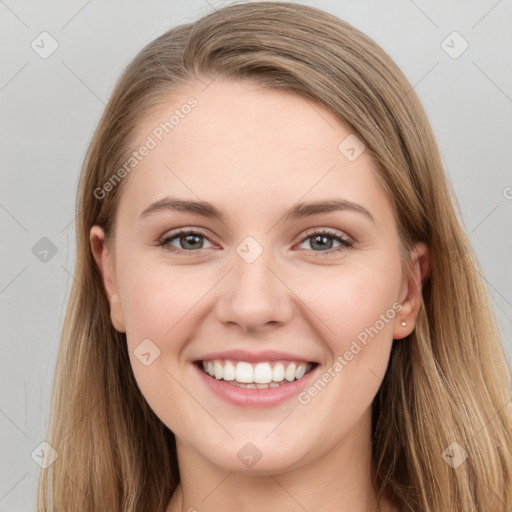 Joyful white young-adult female with long  brown hair and grey eyes